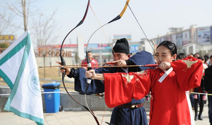 兰州数十名汉服爱好者在当地雁滩公园上演"汉服秀",展示古代射箭技艺