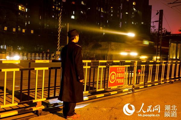 1月16日凌晨2时15分道口工杨佳丽以标准化的作业守护着道口过往行人和列车的安全。王鸿钧 摄