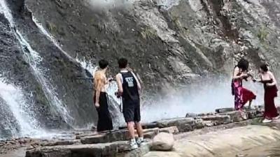 杭州一景区瀑布石头滚落险砸中游客，当地：水流冲击所致