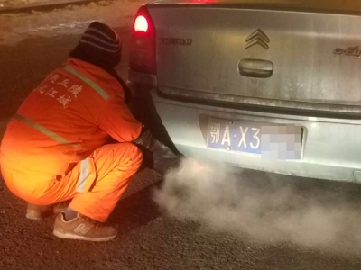 环卫工蹲出租车排气管旁暖手 受邀上车又下车：怕弄脏